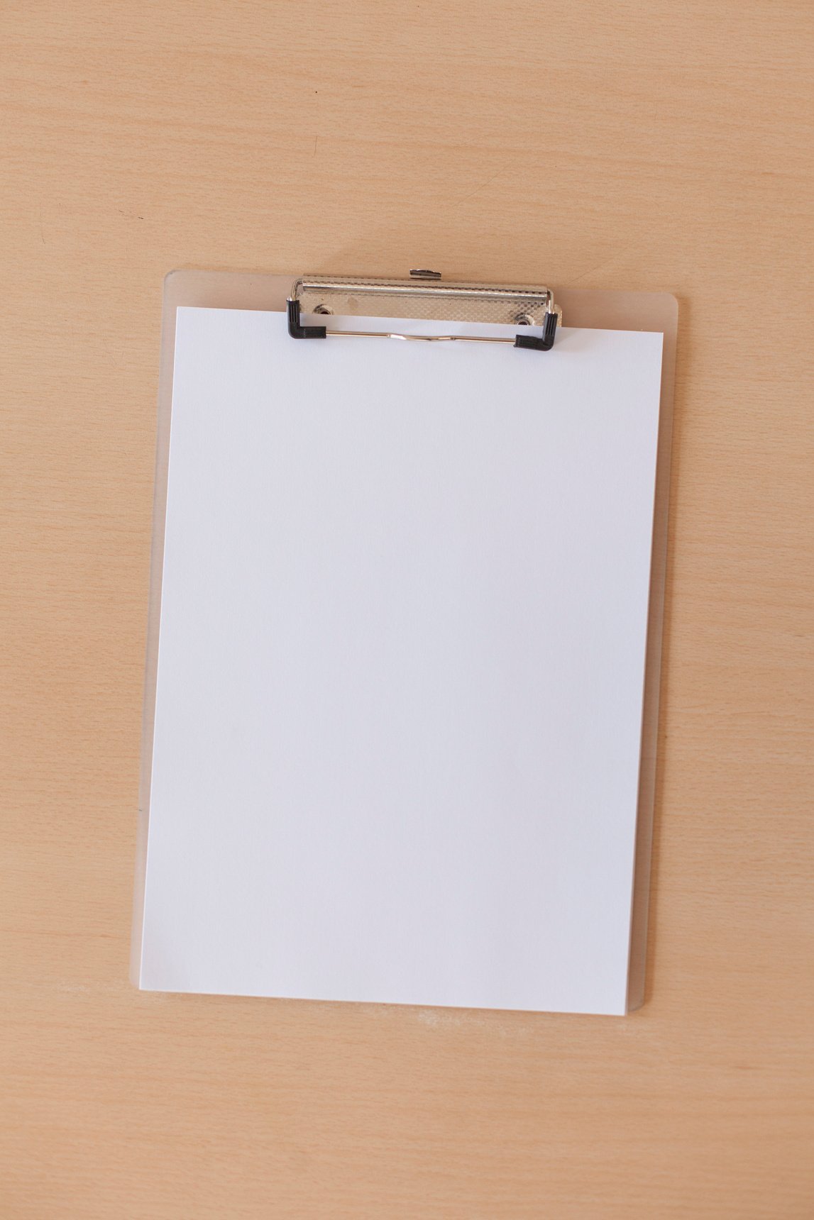 Blank clipboard on a table.